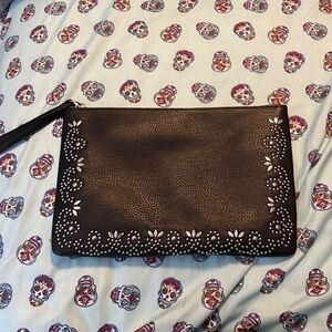 Unknown brand silver studded clutch in black with and attached strap.